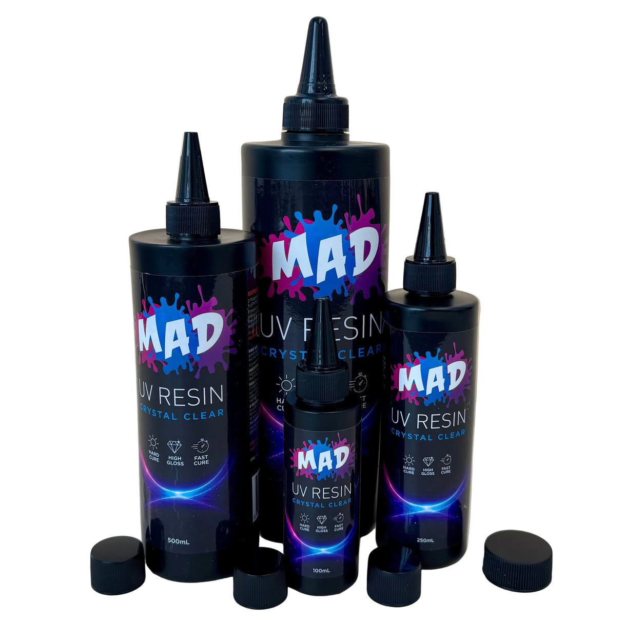 Three black squeeze bottles of MAD UV Resin Crystal Clear in different sizes, with nozzels on top and their caps removed and placed in front of them.