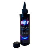 A bottle of MAD UV Resin Crystal Clear, with a nozzel on and cap removed and placed beside it on a white background.