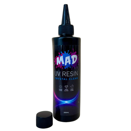 A bottle of MAD UV Resin Crystal Clear, with a nozzel on and cap removed and placed beside it on a white background.